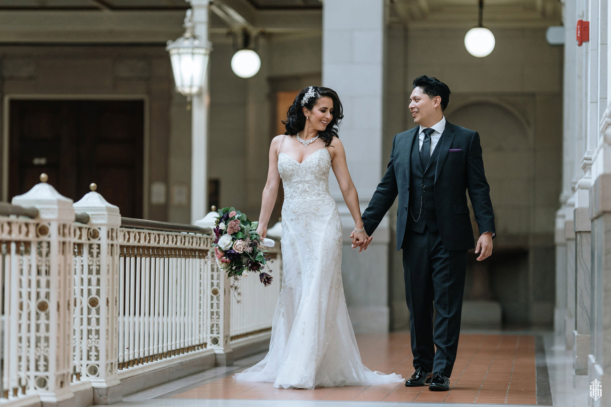 Couple on the mezzanine balcony overlooking the ballroom at Society Room