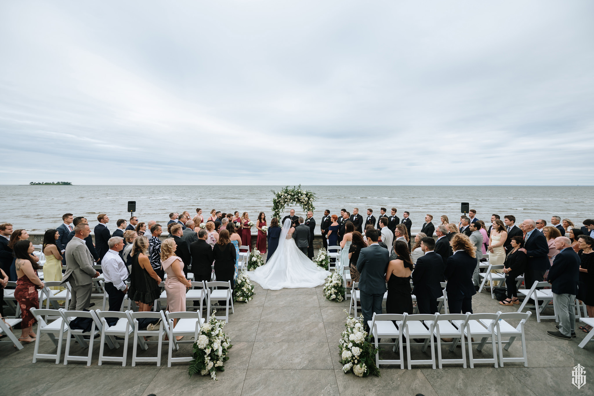 Ceremony aisle on the waterfront lawn with Charles Island in the background