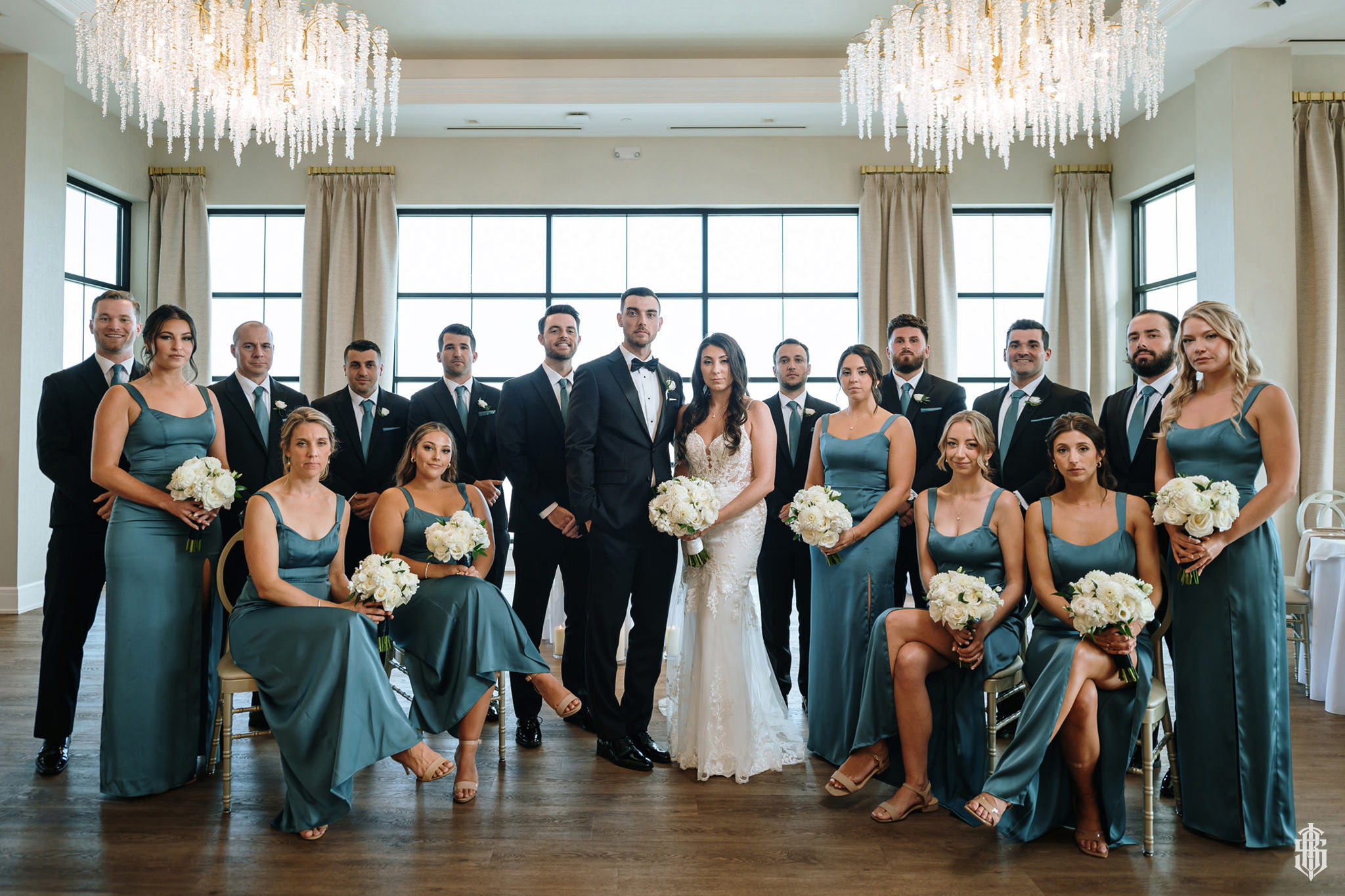 Brianna and Nolan first dance in the ballroom with chandelier light overhead