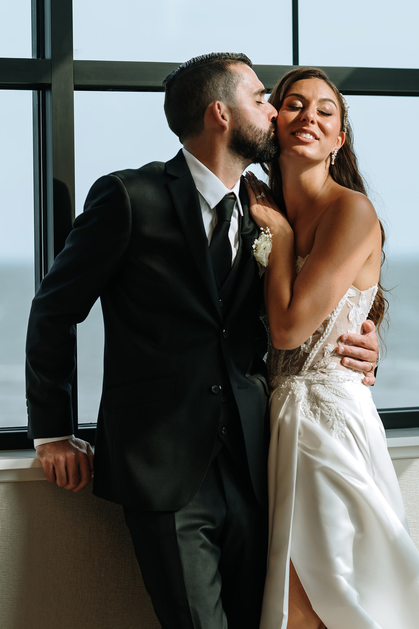 Jamie and Will dancing under string lights at their coastal reception