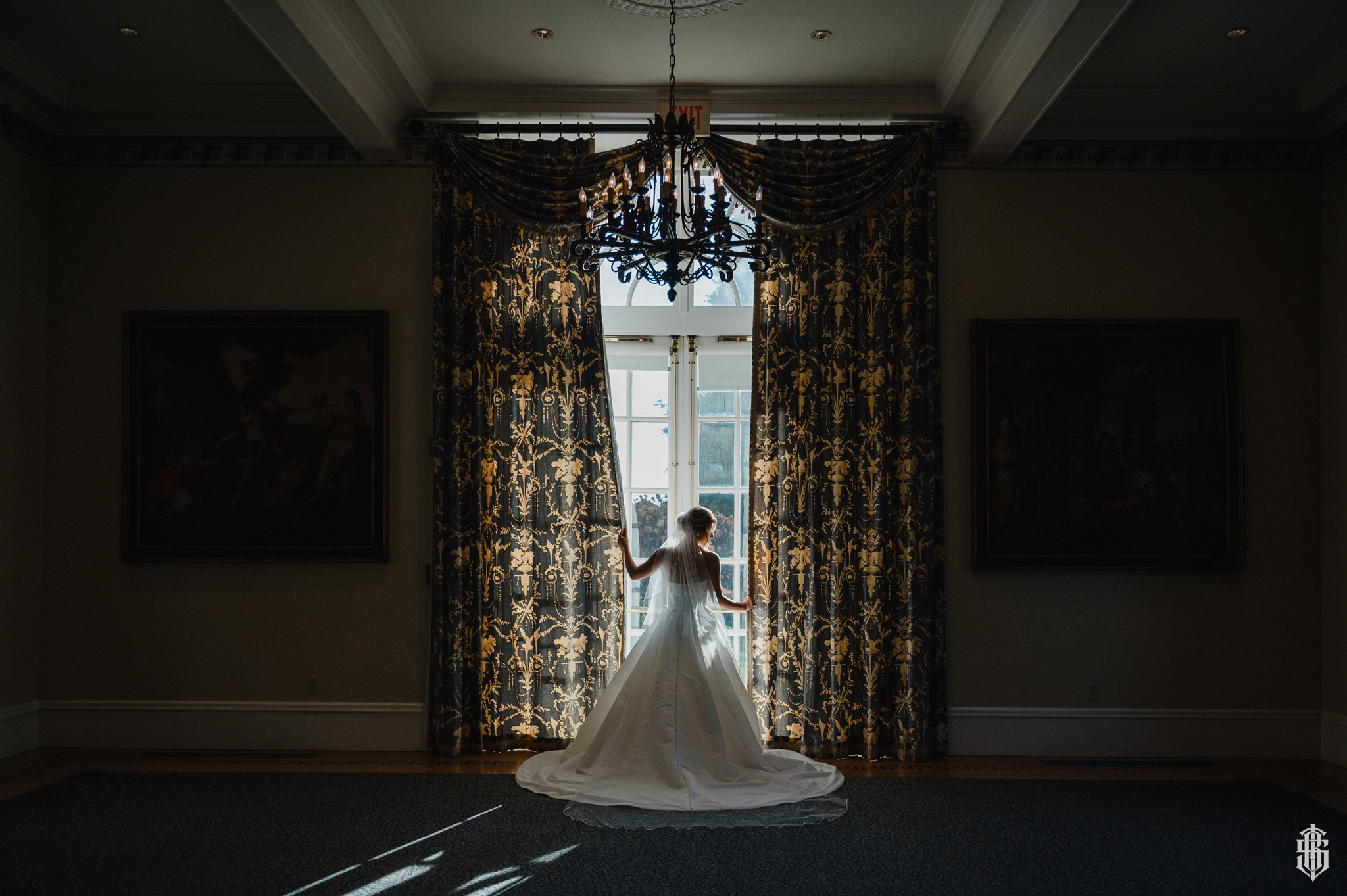 Intimate couple portrait framed by classical stone columns on the terrace