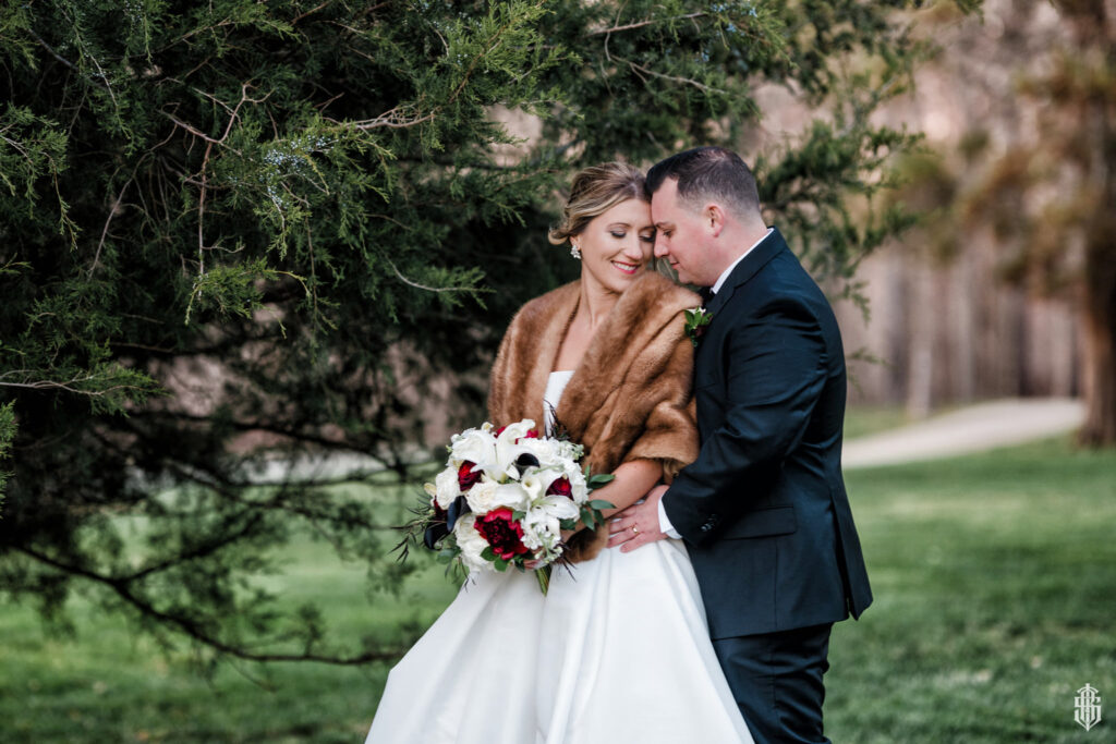 Couple sharing a tender moment among the towering Eastern Red Cedars