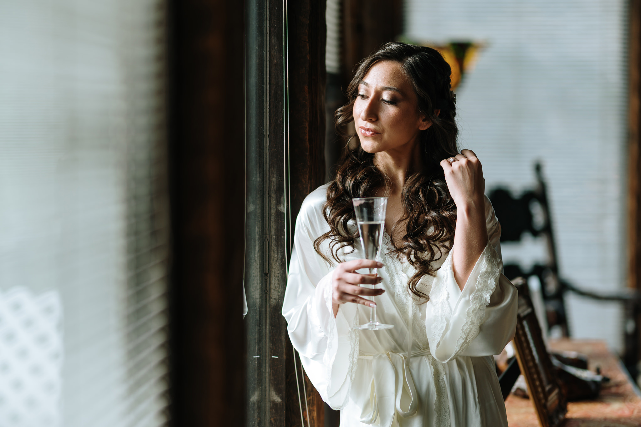 Portrait of the bride at the window at Bill Miller's Castle Bridal Suite, Bruno Sauma Photography